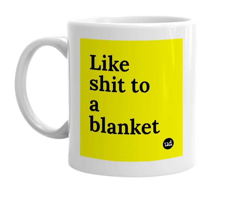 White mug with 'Like shit to a blanket' in bold black letters