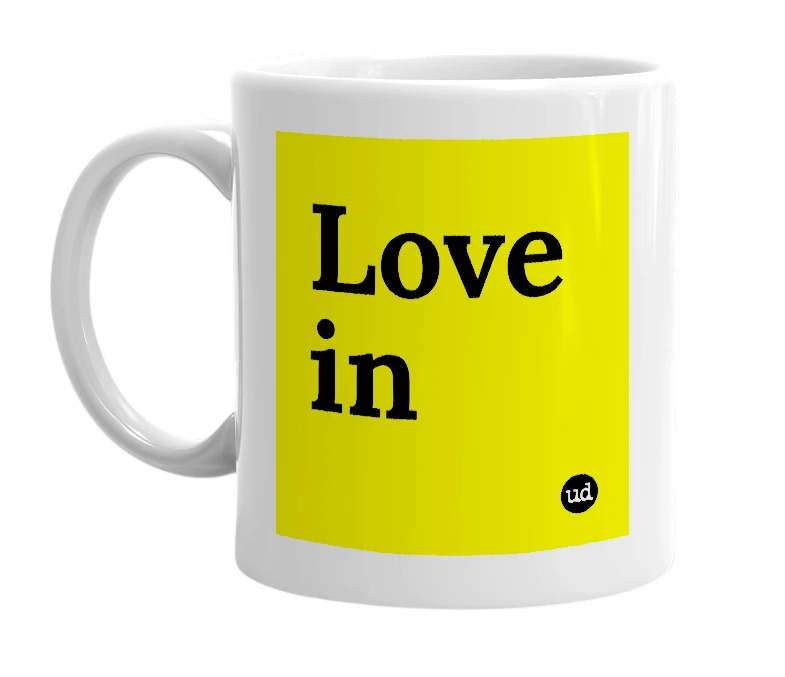 White mug with 'Love in' in bold black letters