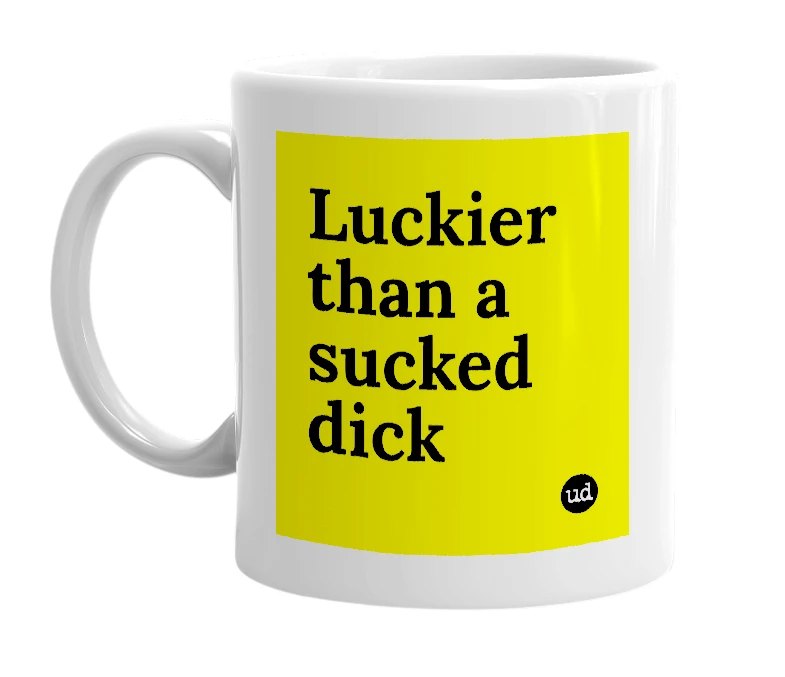 White mug with 'Luckier than a sucked dick' in bold black letters