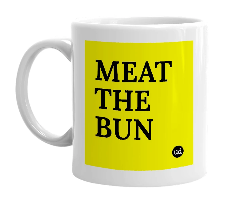 White mug with 'MEAT THE BUN' in bold black letters