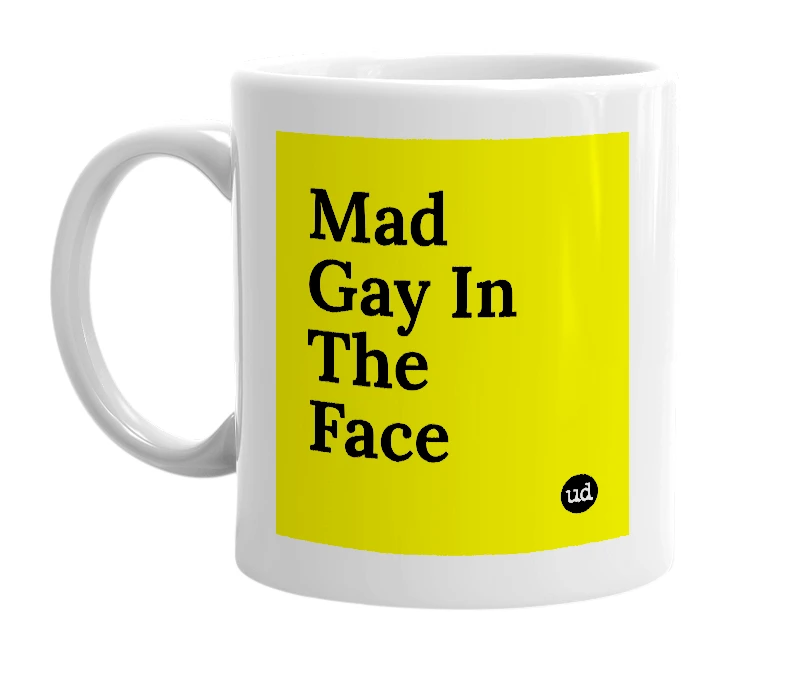 White mug with 'Mad Gay In The Face' in bold black letters