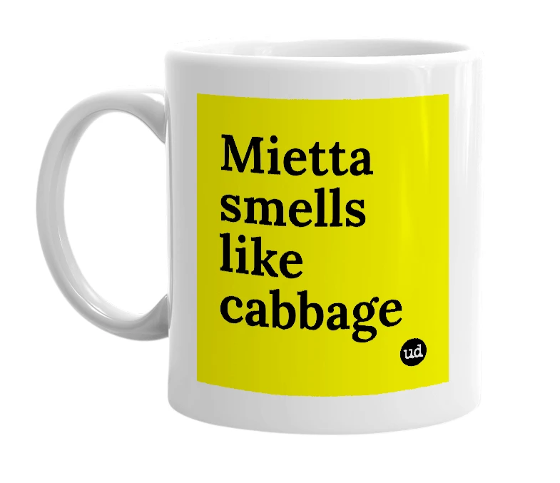 White mug with 'Mietta smells like cabbage' in bold black letters