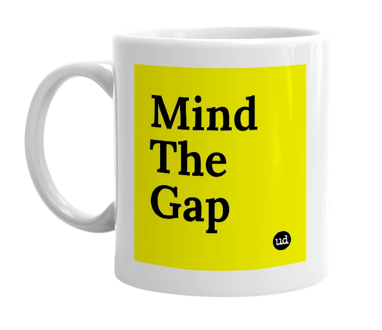 White mug with 'Mind The Gap' in bold black letters