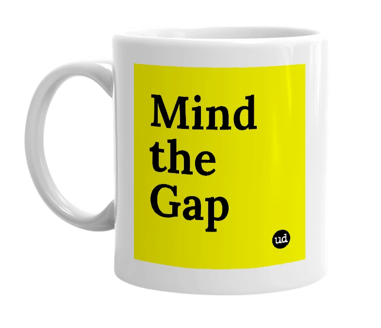 White mug with 'Mind the Gap' in bold black letters