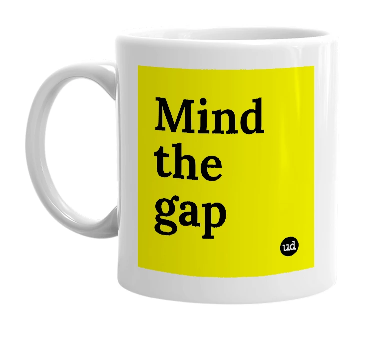 White mug with 'Mind the gap' in bold black letters