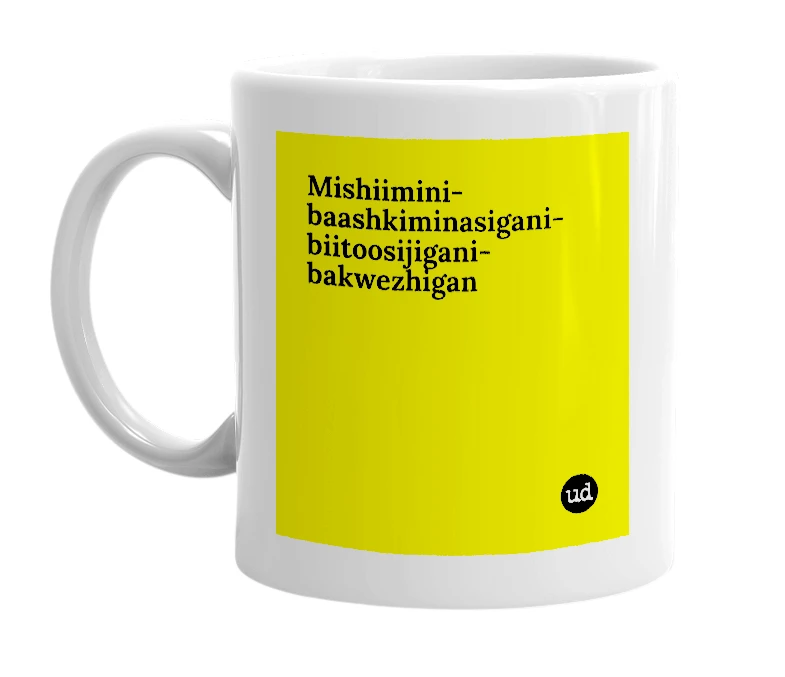 White mug with 'Mishiimini-baashkiminasigani-biitoosijigani-bakwezhigan' in bold black letters