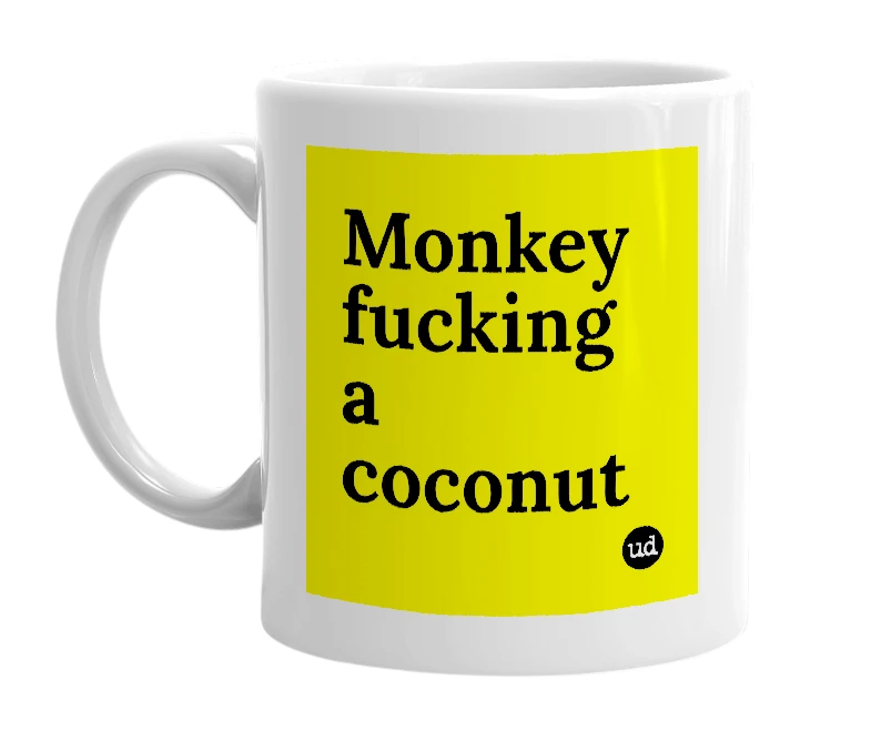 White mug with 'Monkey fucking a coconut' in bold black letters