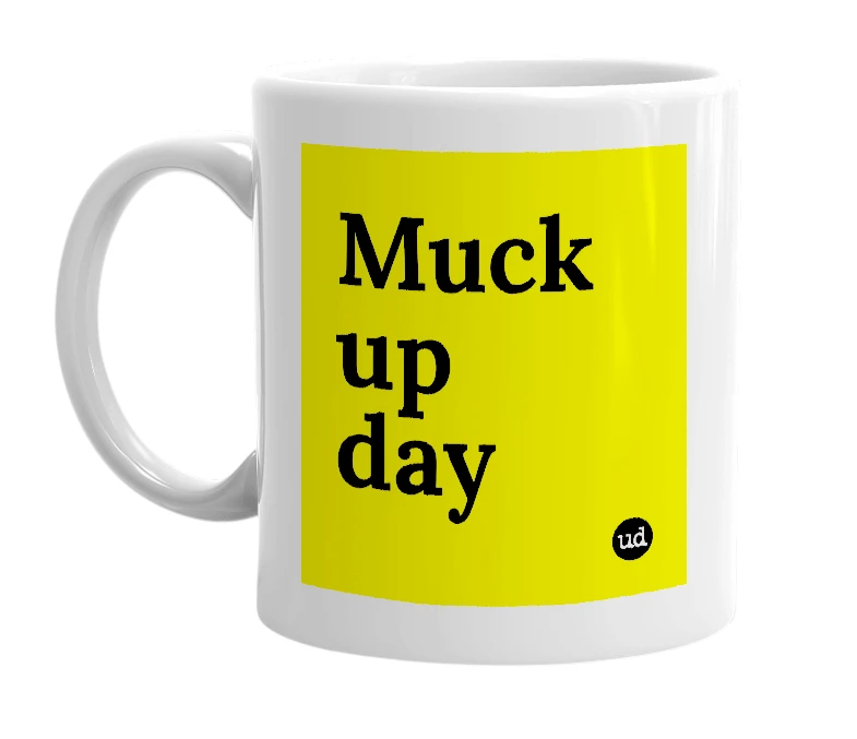 White mug with 'Muck up day' in bold black letters