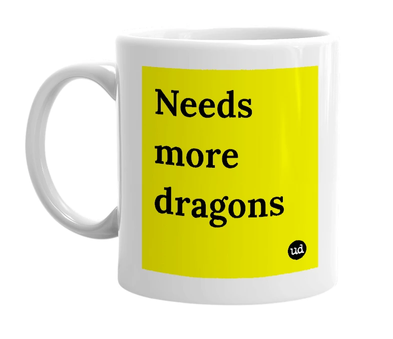 White mug with 'Needs more dragons' in bold black letters