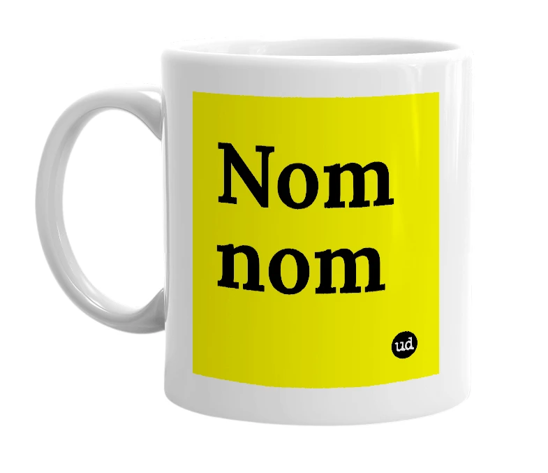 White mug with 'Nom nom' in bold black letters