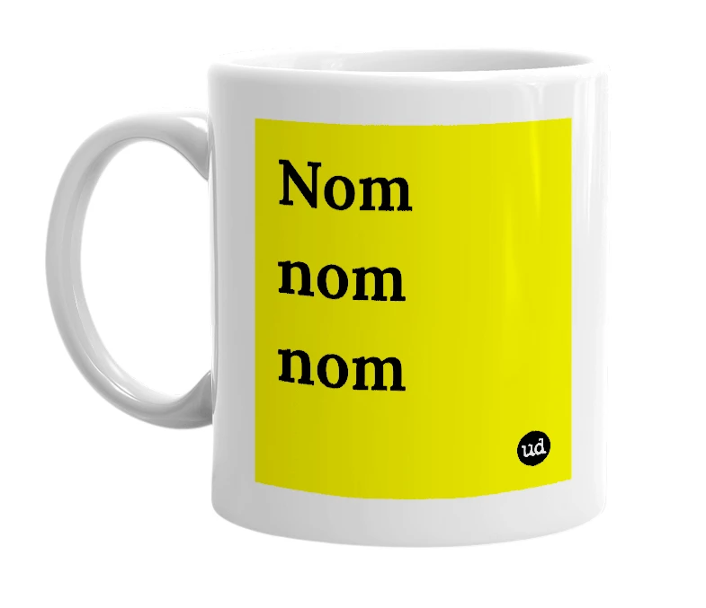 White mug with 'Nom nom nom' in bold black letters