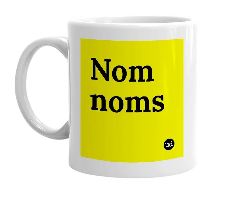 White mug with 'Nom noms' in bold black letters