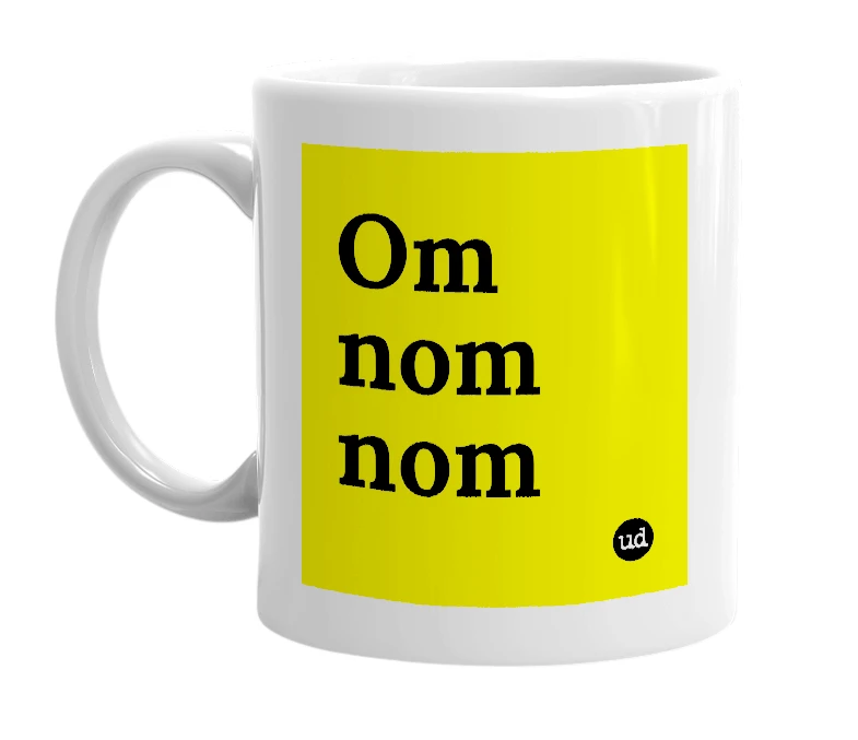 White mug with 'Om nom nom' in bold black letters