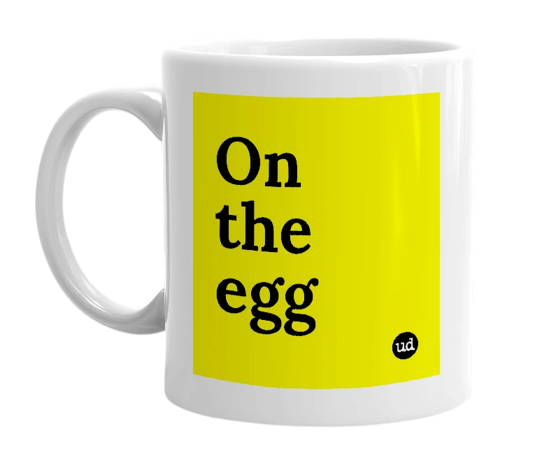 White mug with 'On the egg' in bold black letters