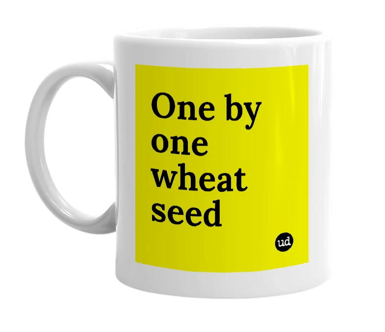 White mug with 'One by one wheat seed' in bold black letters