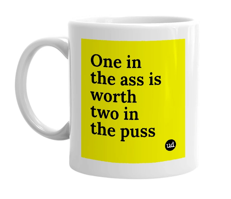 White mug with 'One in the ass is worth two in the puss' in bold black letters