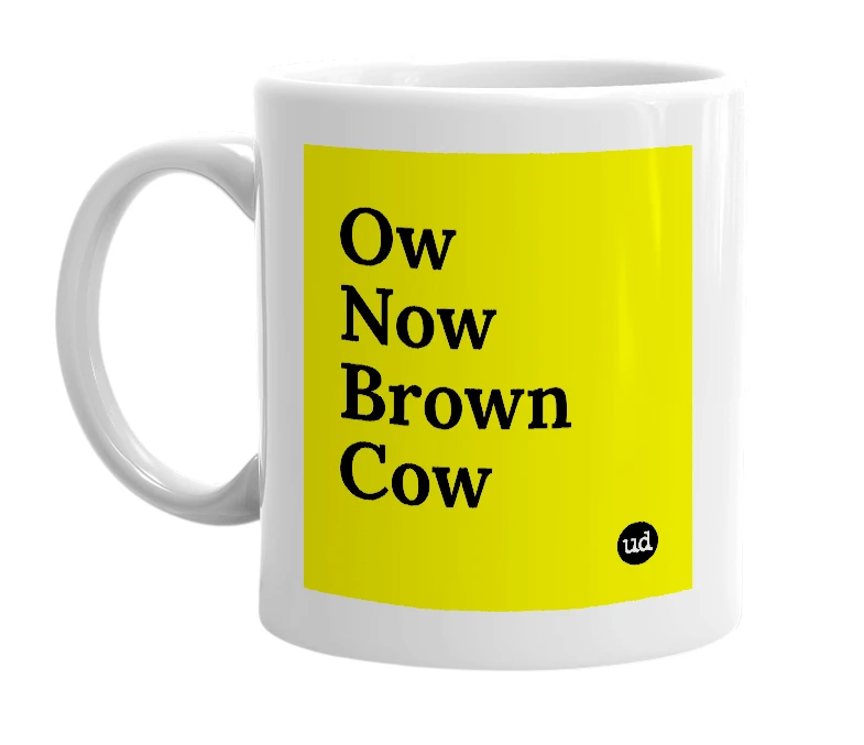 White mug with 'Ow Now Brown Cow' in bold black letters