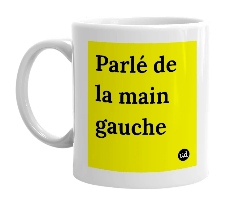 White mug with 'Parlé de la main gauche' in bold black letters