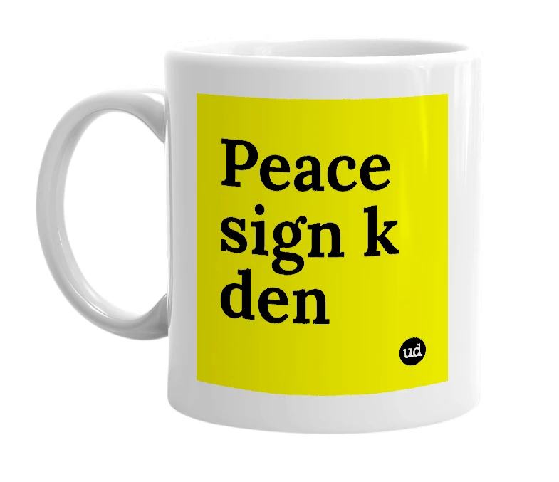 White mug with 'Peace sign k den' in bold black letters