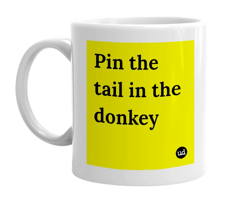 White mug with 'Pin the tail in the donkey' in bold black letters
