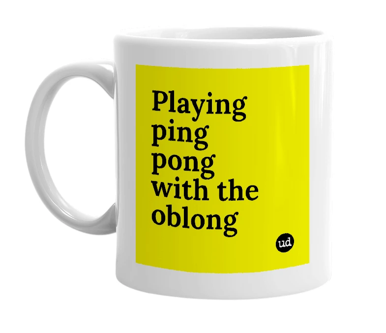 White mug with 'Playing ping pong with the oblong' in bold black letters