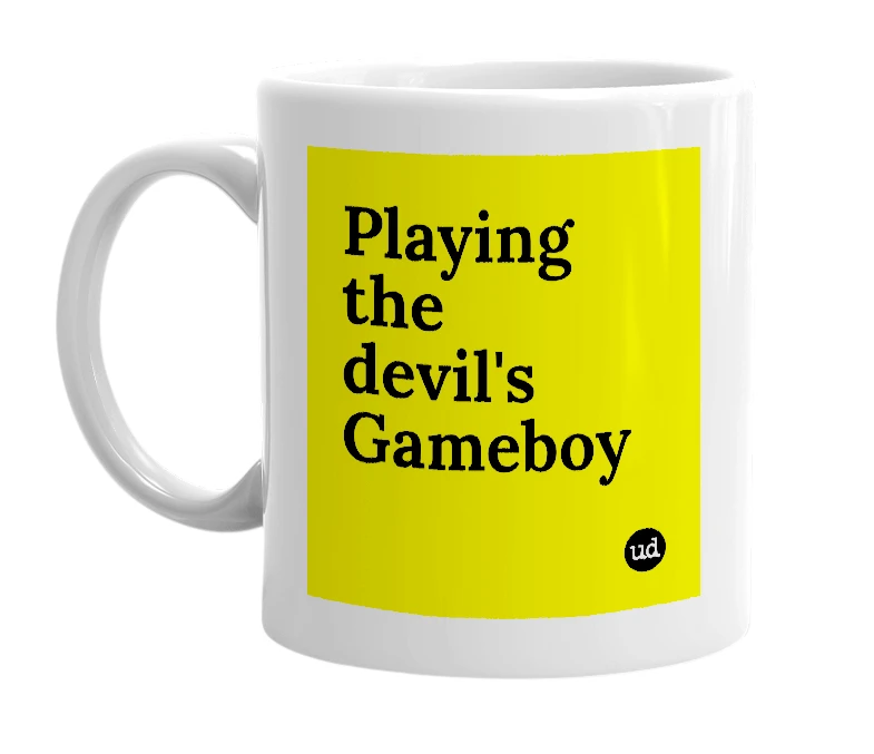 White mug with 'Playing the devil's Gameboy' in bold black letters