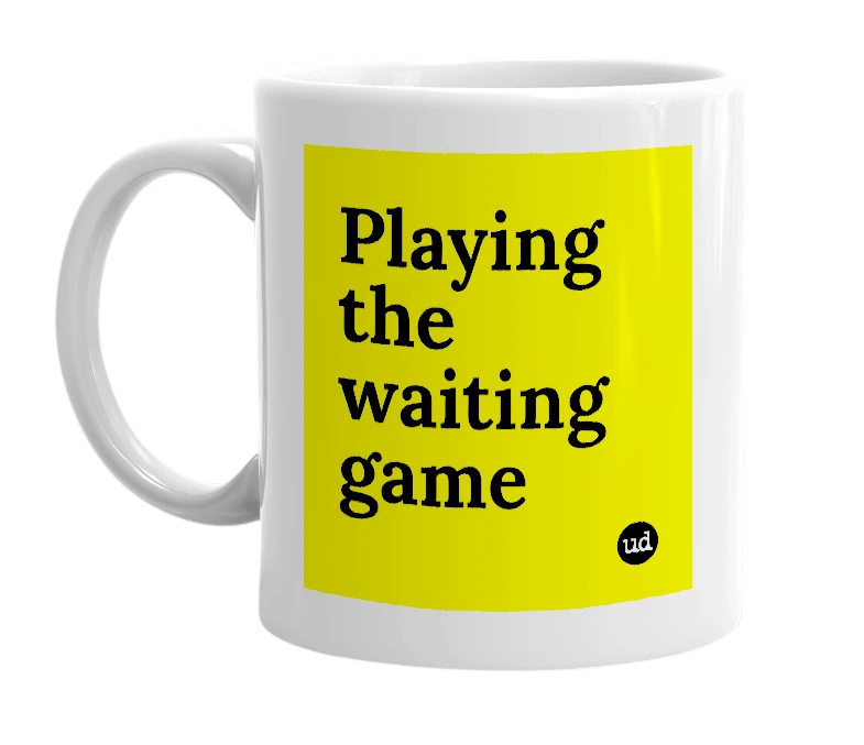 White mug with 'Playing the waiting game' in bold black letters