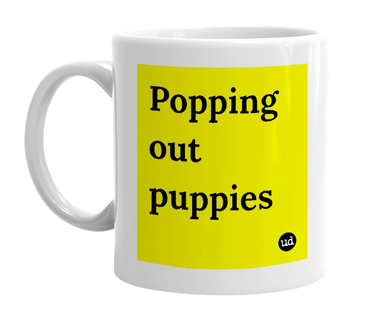 White mug with 'Popping out puppies' in bold black letters