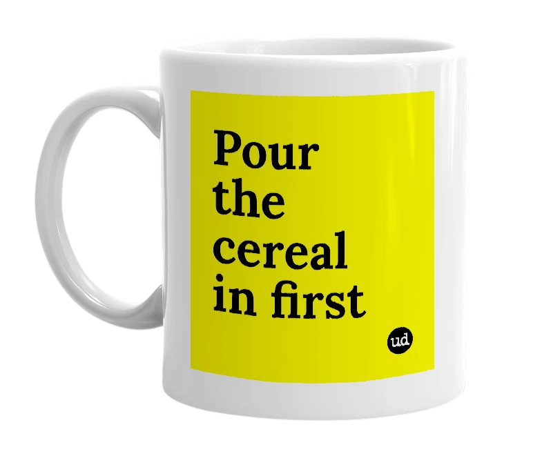 White mug with 'Pour the cereal in first' in bold black letters