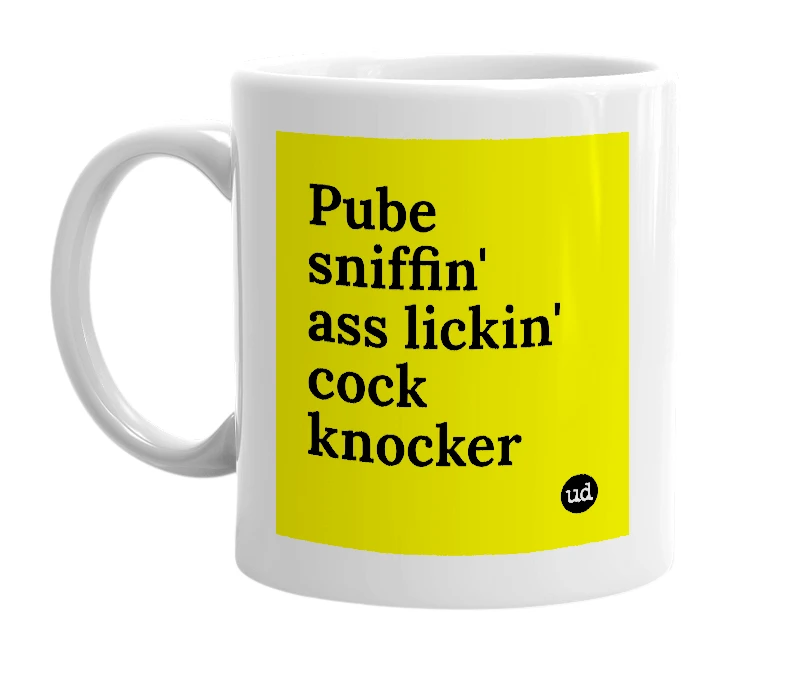 White mug with 'Pube sniffin' ass lickin' cock knocker' in bold black letters
