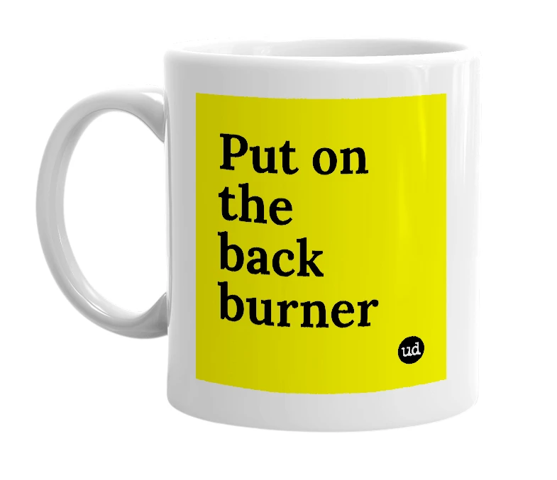 White mug with 'Put on the back burner' in bold black letters