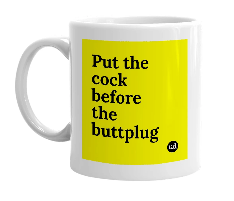 White mug with 'Put the cock before the buttplug' in bold black letters