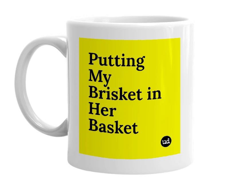 White mug with 'Putting My Brisket in Her Basket' in bold black letters