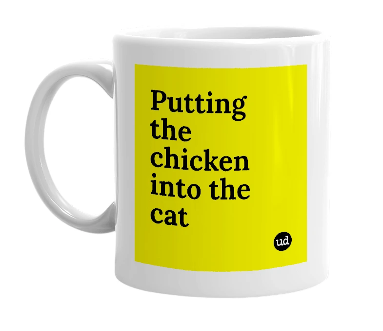 White mug with 'Putting the chicken into the cat' in bold black letters