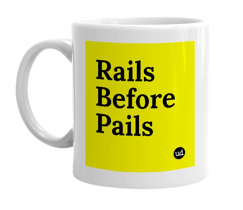 White mug with 'Rails Before Pails' in bold black letters