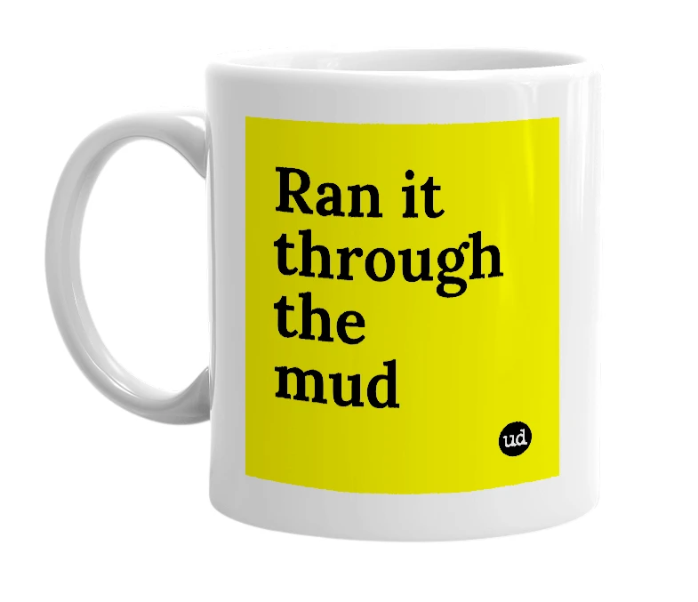 White mug with 'Ran it through the mud' in bold black letters