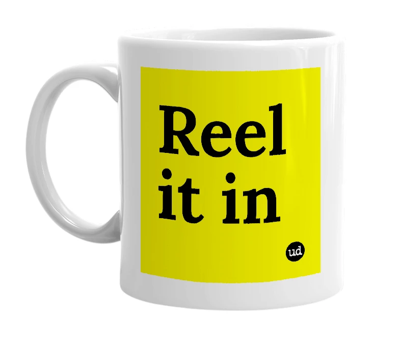 White mug with 'Reel it in' in bold black letters