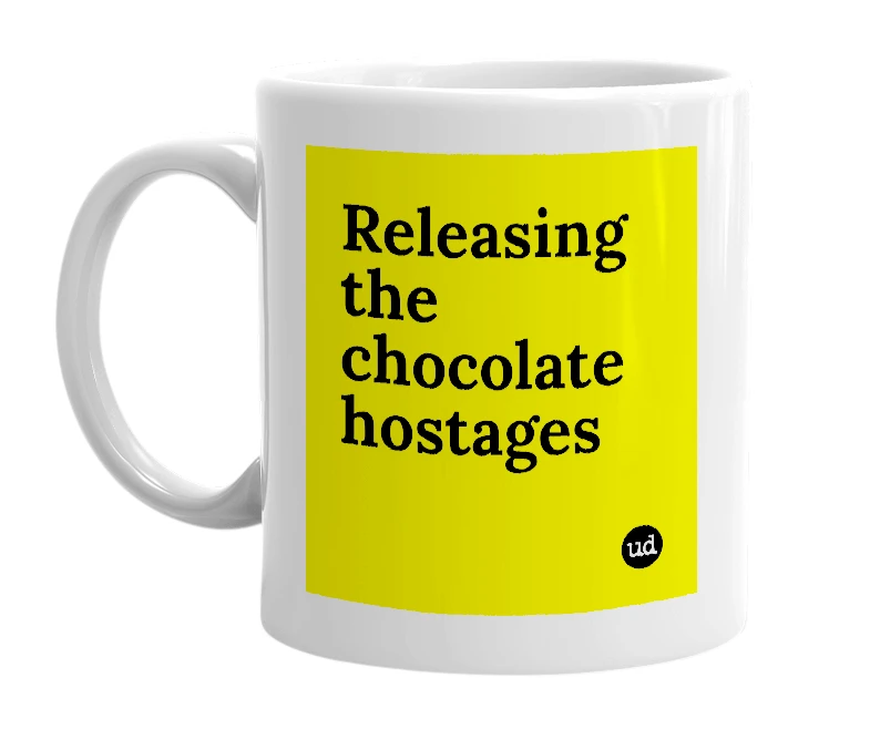 White mug with 'Releasing the chocolate hostages' in bold black letters