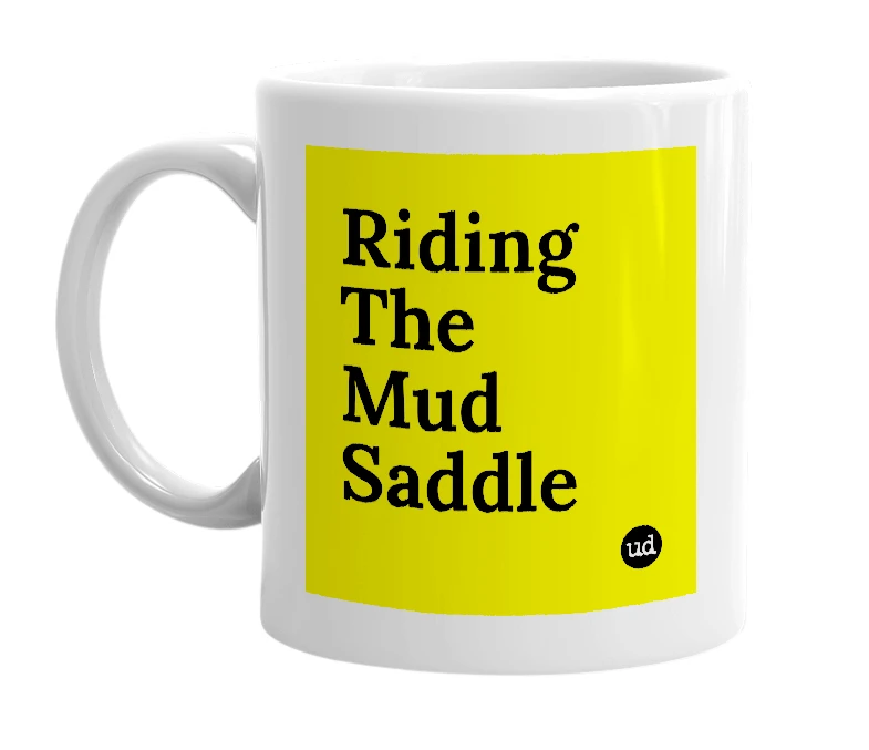 White mug with 'Riding The Mud Saddle' in bold black letters