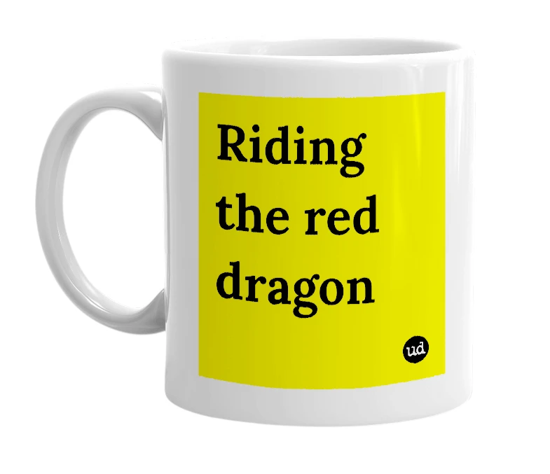 White mug with 'Riding the red dragon' in bold black letters