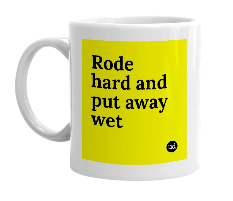 White mug with 'Rode hard and put away wet' in bold black letters