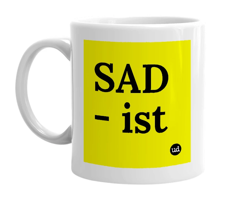 White mug with 'SAD - ist' in bold black letters