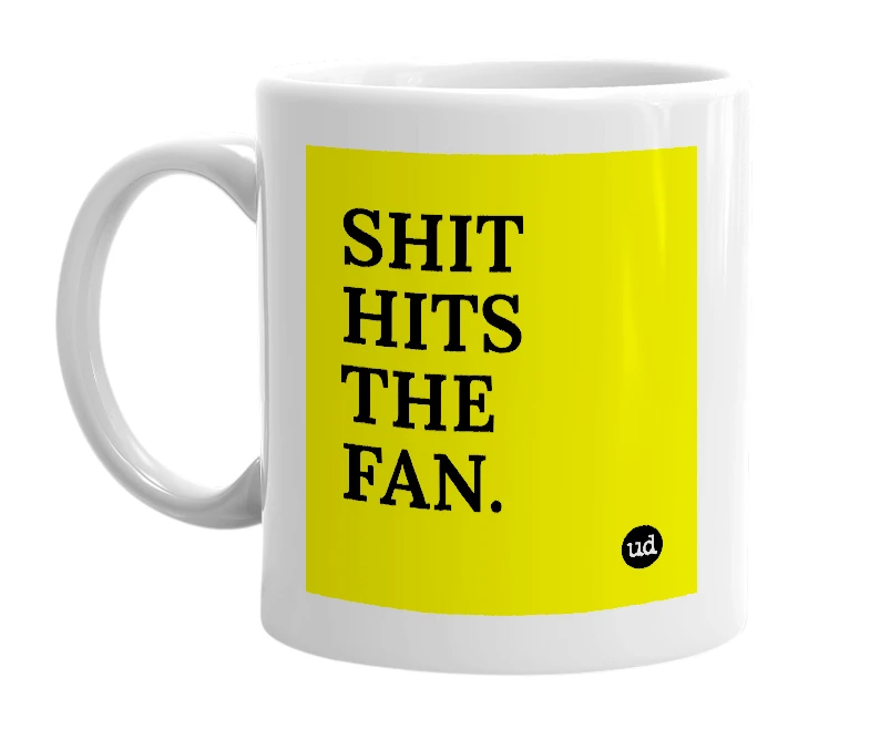 White mug with 'SHIT HITS THE FAN.' in bold black letters