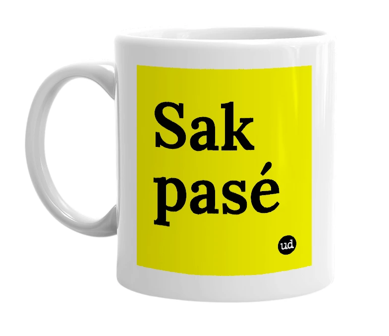 White mug with 'Sak pasé' in bold black letters