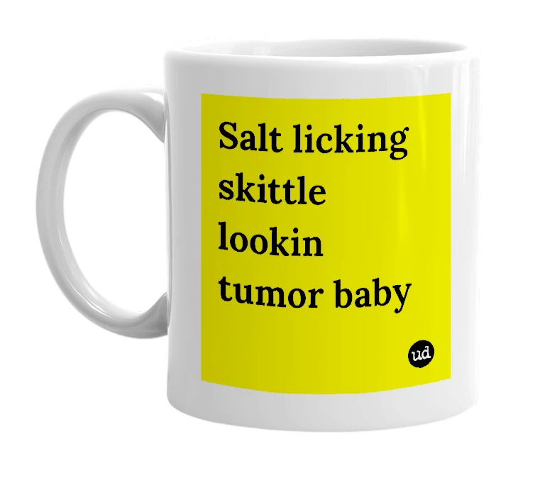 White mug with 'Salt licking skittle lookin tumor baby' in bold black letters