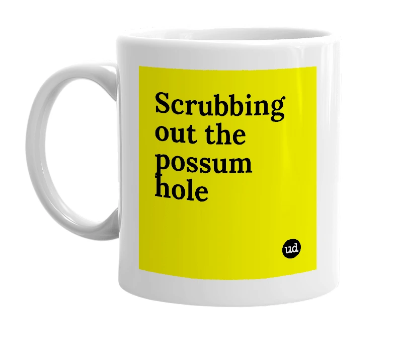 White mug with 'Scrubbing out the possum hole' in bold black letters