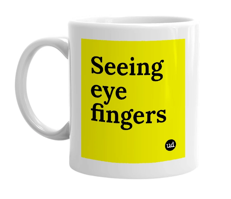 White mug with 'Seeing eye fingers' in bold black letters