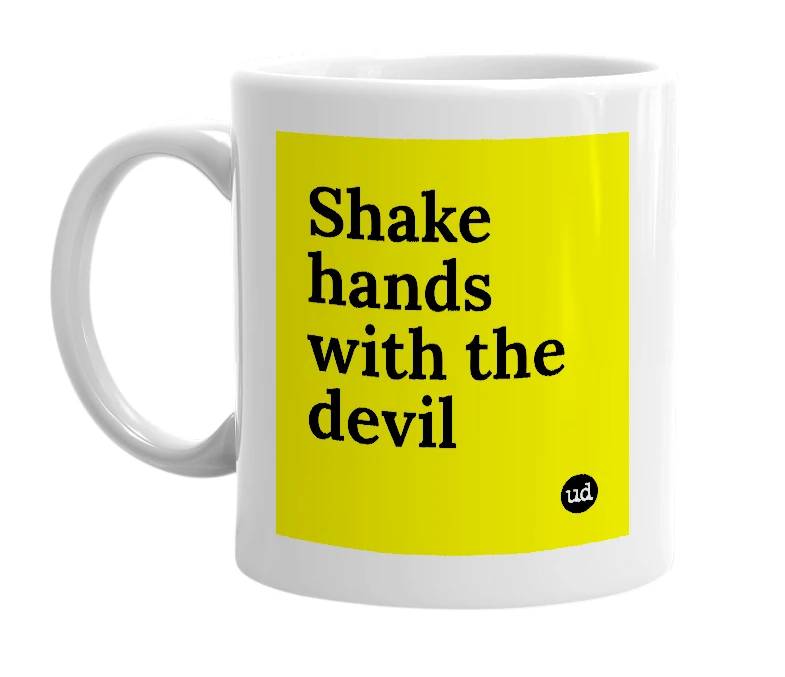 White mug with 'Shake hands with the devil' in bold black letters