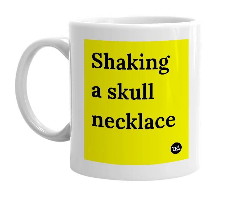 White mug with 'Shaking a skull necklace' in bold black letters