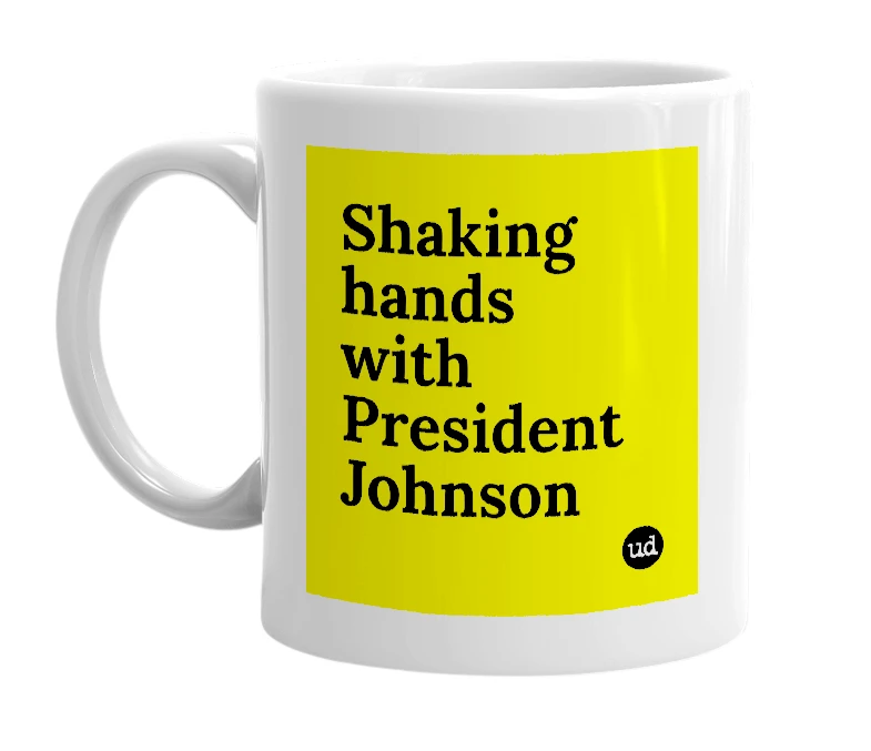 White mug with 'Shaking hands with President Johnson' in bold black letters